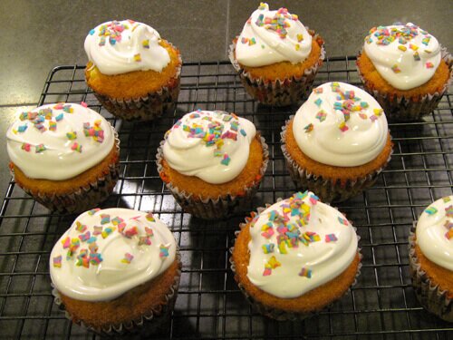 Cupcakes with white frosting and butterfly sprinkles